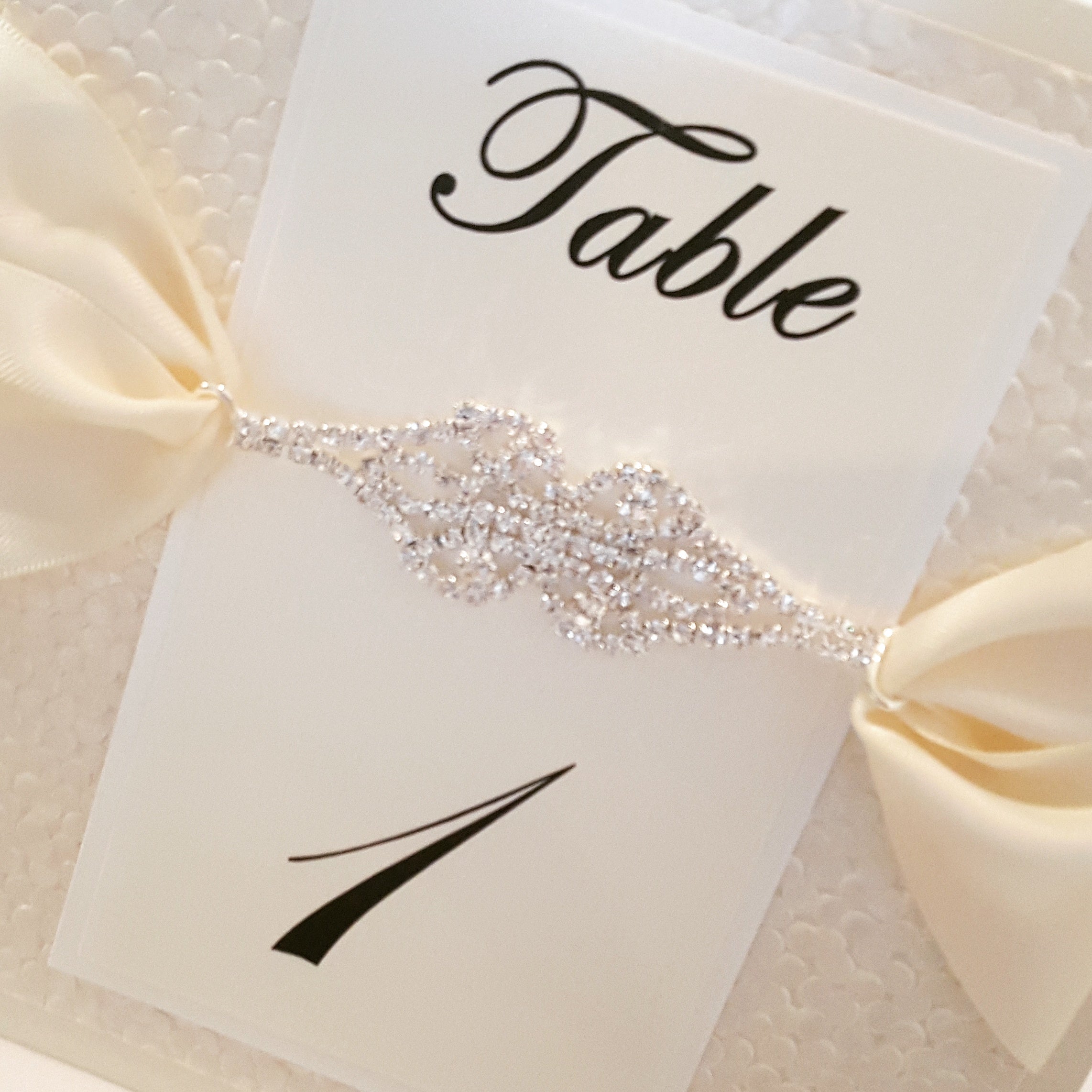 Luxury Pebbles Table Numbers with a Gorgeous Jewel Rhinestone Connector.